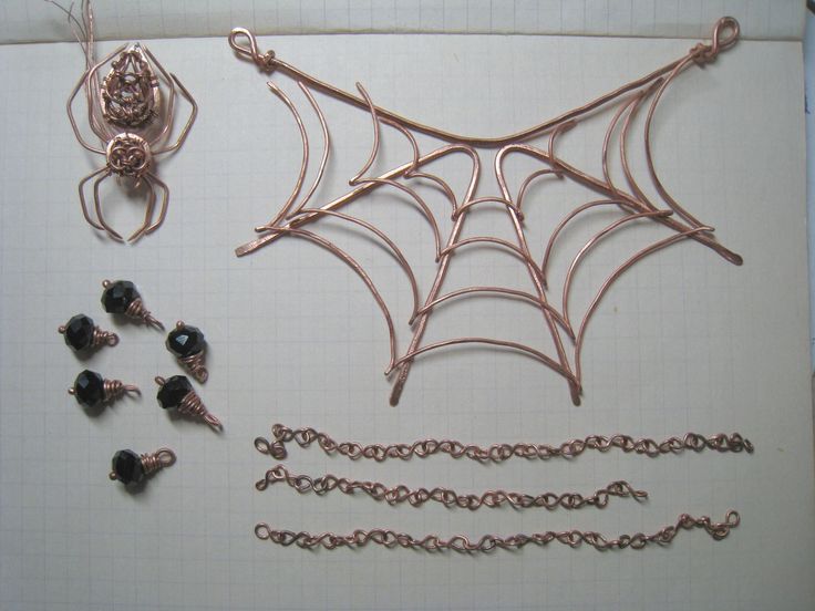 some metal items are laying out on a sheet of paper with wires attached to them