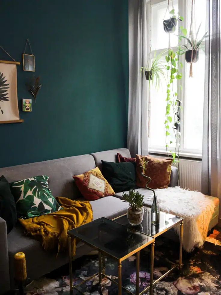 a living room filled with furniture and green walls