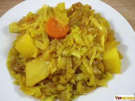 a white plate topped with cabbage and carrots