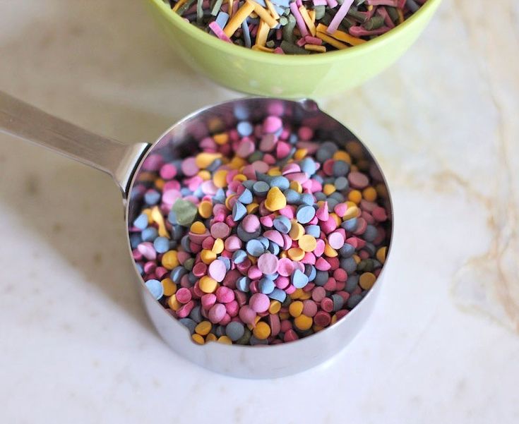 two bowls filled with sprinkles on top of a table