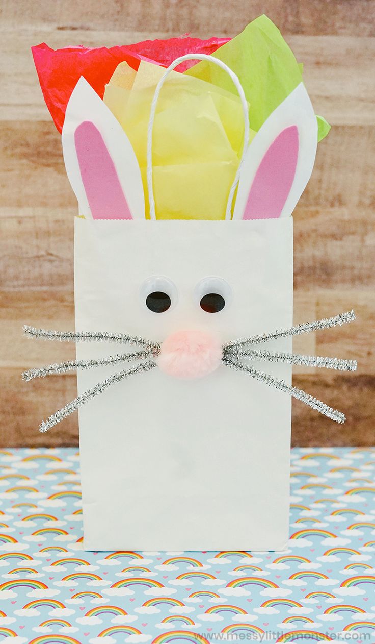 a paper bag that has some bunny ears on it and is sitting on a table