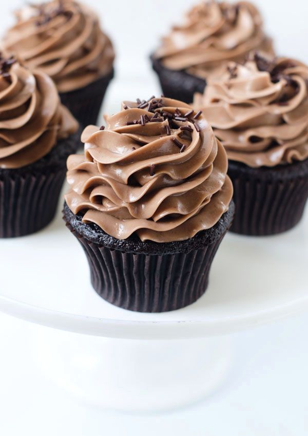 chocolate cupcakes with frosting on a white plate