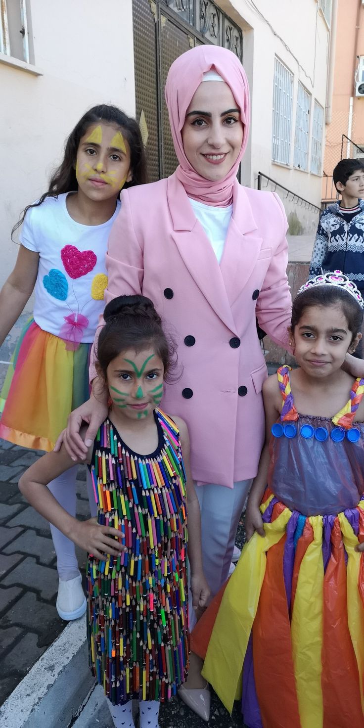 two girls and one girl are dressed up in colorful costumes while standing next to each other