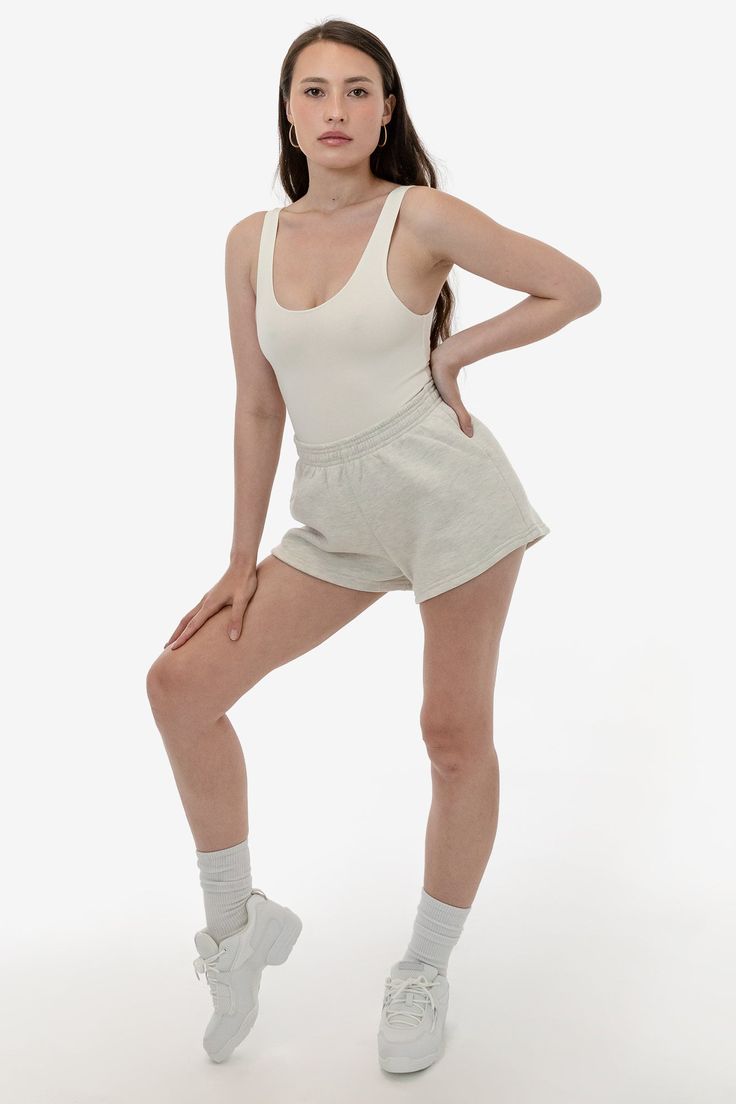 These short shorts are made of our bouncy 12 oz. cotton fleece, making them comfy, easy and versatile. Take your regular size or size up for a looser fit. This style features an elastic waistband, and a single back pocket. Try pairing with our matching sweatshirts or a neutral crop top or bodysuit. This fleece is made of a soft, combed cotton to keep you cozy and warm. Made in Los Angeles, Calif. Our experienced sewers earn up to $25 an hour and no less than $16; additionally workers have health Comfy Solid Color Short Bottoms, Basic Cotton Shorts For Summer, Comfy Bottoms With Elastic Waistband And Short Length, Comfortable Short Bottoms With Ribbed Waistband, Everyday Cotton Pajama Shorts With Elastic Waistband, Comfortable Relaxed Fit Shorts With Elastic Waistband, Basic Bottoms With Ribbed Waistband And Short Length, Relaxed Stretch Short Bottoms, Casual Mid-thigh Length Cotton Bottoms