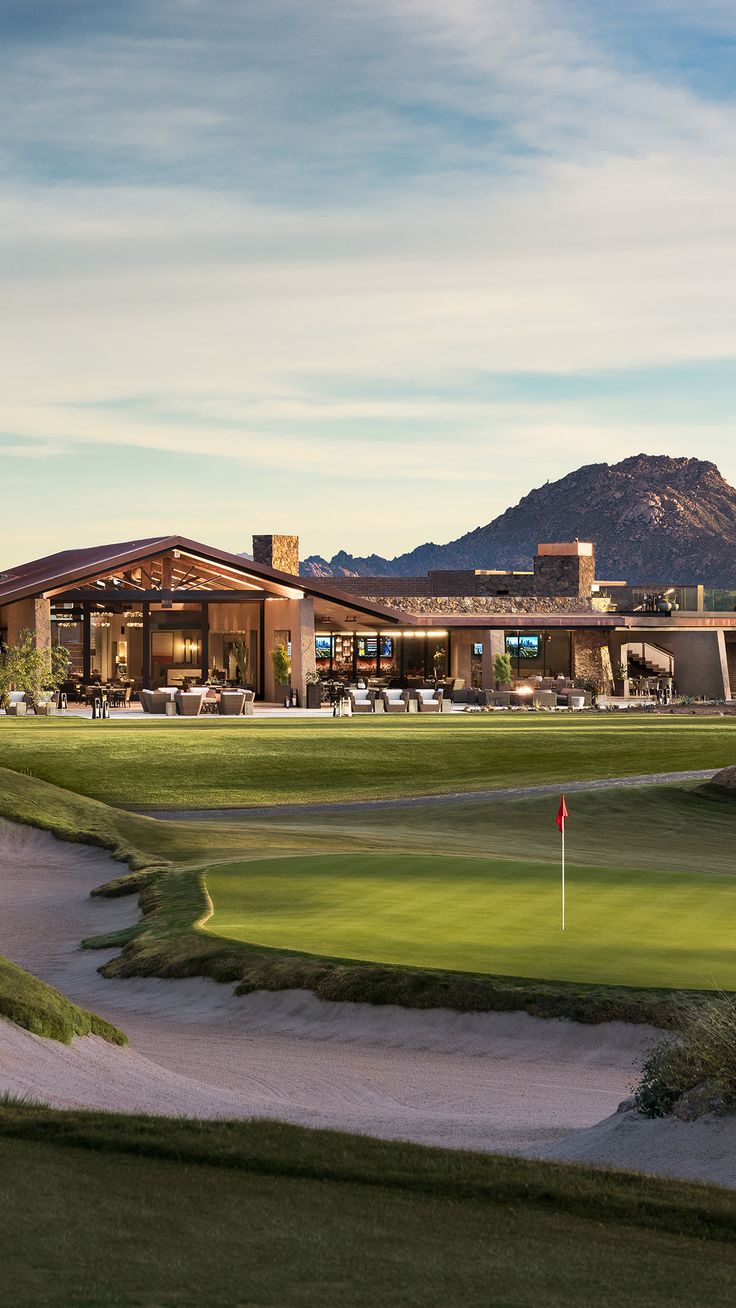 a golf course with mountains in the background