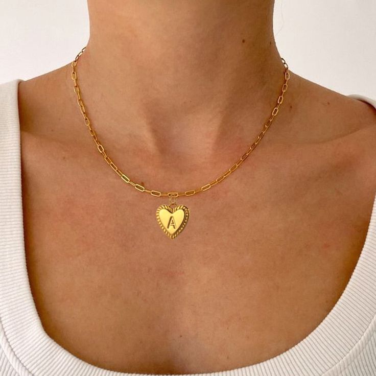 Personalize your wardrobe with the YourLetter Heart Necklace. This stylish piece of jewelry features an elegant gold-colored heart design, and allows you to choose the letter of your choice, making it a unique and thoughtful gift. Express yourself and stay stylish with this personalized necklace.