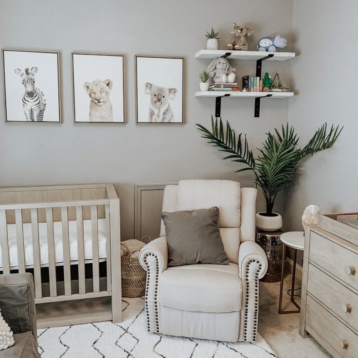 a baby's room with white furniture and pictures on the wall