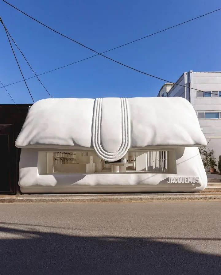 a large white bag sitting on the side of a road next to a tall building