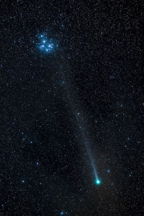 the comet is shining brightly in the night sky