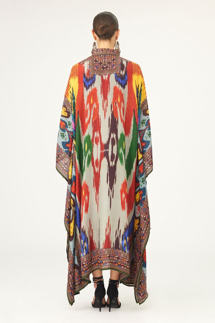 Multi color kaftan crafted in silk base with abstract print.
Components: 1
Pattern: Print
Type Of Work: Abstract
Neckline: Collared Neck
Sleeve Type: Batwing Sleeves
Fabric: Silk
Color: Multi Color
Other Details: 
Geometric print placket and edges
Half button closure
Occasion: Resort - Aza Fashions Red Bohemian Kaftan With Ikat Print, Long Multicolor Kimono For Festivals, Traditional Printed Maxi Kimono, Traditional Printed Maxi Length Kimono, Traditional Maxi Length Printed Kimono, Silk Kaftan With Digital Print Tunic, Multicolor Long Printed Kimono, Traditional Multicolor Kimono For Vacation, Multicolor Bohemian Kimono For Festivals