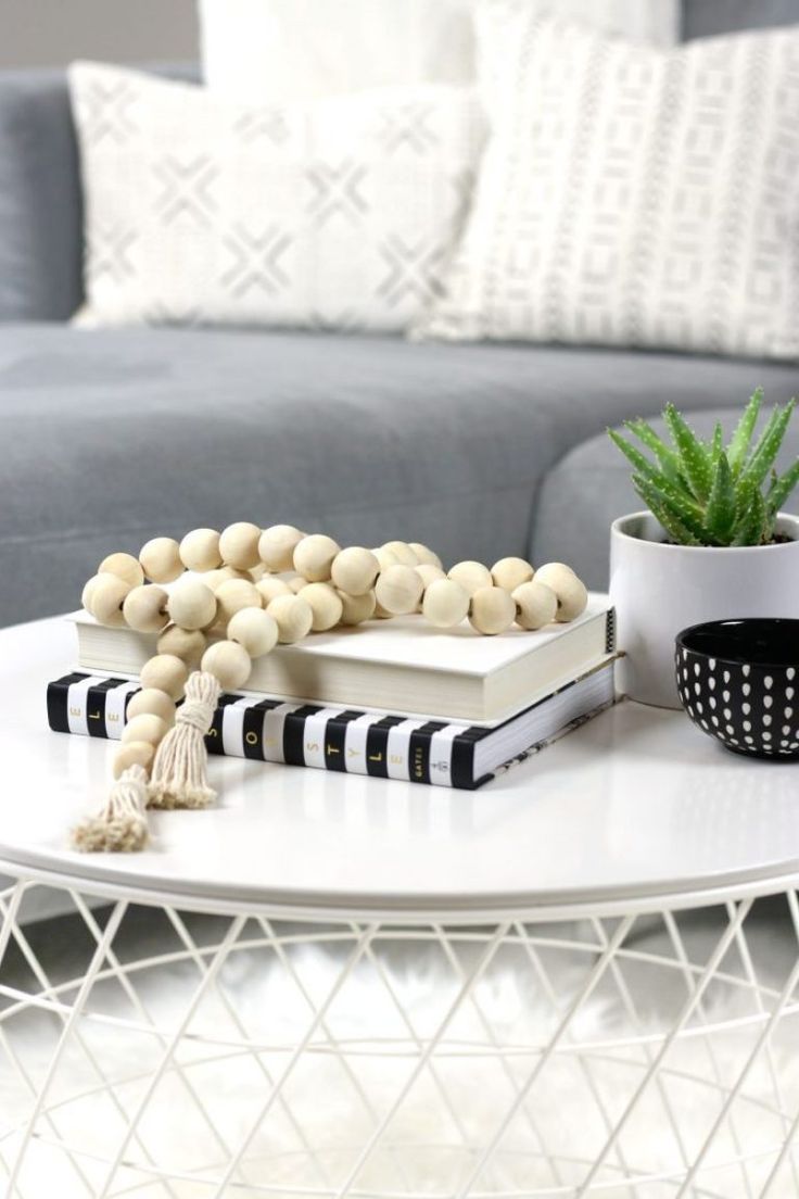 a white table topped with a book and beads