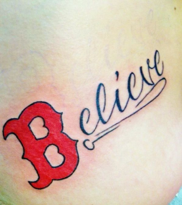 a woman's stomach with the word believe written on it and a red bat