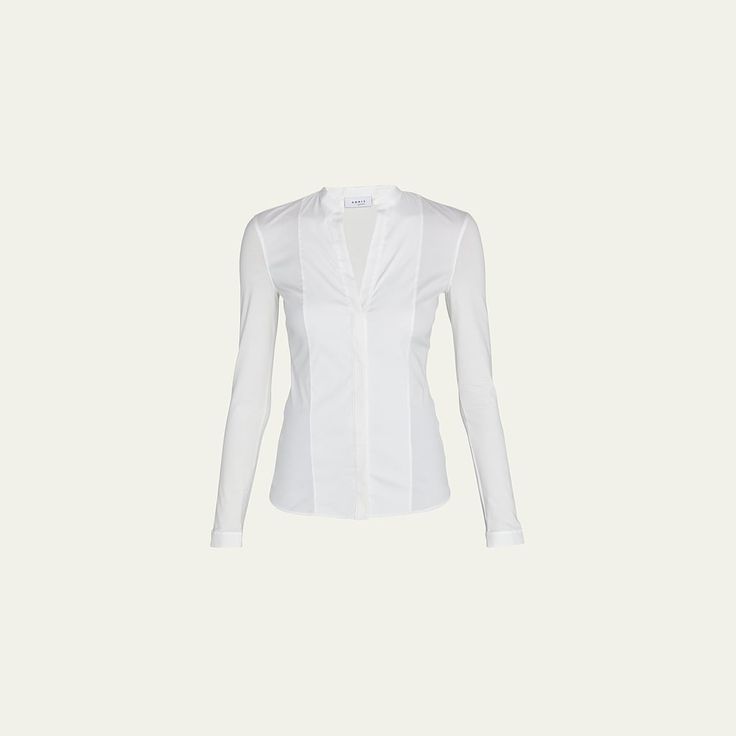 Akris punto blouse in cotton poplin, featuring a jersey back. Split neckline. Long sleeves. Hem hits hips. Fitted. Cotton. Made in Italy. Modern Fitted Blouse For Business Casual, Classic Tops For Workwear, Modern Stretch Blouse For Workwear, Modern Fitted Blouse For Work, Fitted Elastane Tops For Office, Modern Tops With Minimal Stretch For Work, Formal Fitted Top In Elastane, Modern Top With Minimal Stretch For Work, Modern Stretch Tops For Business Casual