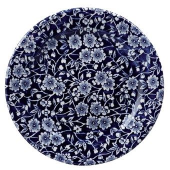 a blue and white plate with flowers on it