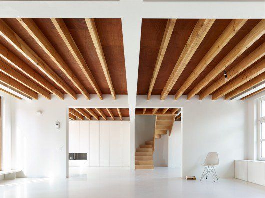 an empty room with white walls and wooden beams on the ceiling is seen in this instagramted post