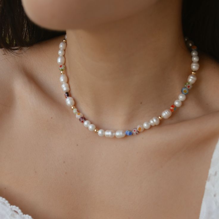 This Millefiori Pearl Necklace is a timeless piece suitable for any season to add a pop of color and fun to your outfit. Each necklace is beaded in a unique pattern, which means each necklace is different from the others, this delicate design makes it perfect for an effortless look. DETAILS:Water Resistant - Allergy-free18k Goldplated Stainless Steel Clasps, Ivory Freshwater Pearls, Millefiori Glass BeadsGold-filled seed beadsONE SIZE 16.5 inches NOTE: All designs are unique, photos are for refe Chunky Glass Bead Necklace, Millefiori Jewellery, Summer Glowup, Best Jewellery Design, Ocean Ecosystem, Natural Pearl Necklace, Unique Photos, Capsule Closet, Pearl Necklace Designs