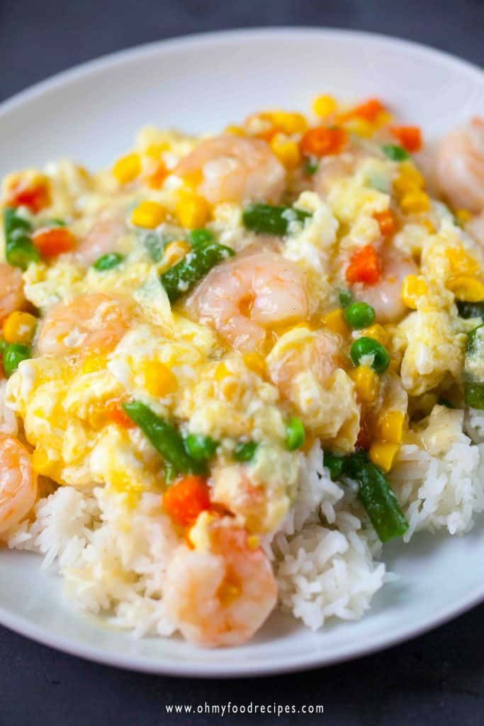 shrimp and rice with vegetables on a white plate