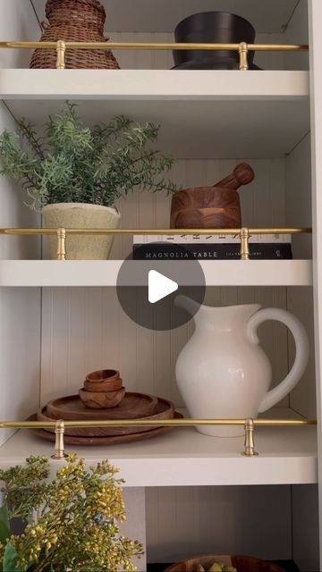 the shelves in this kitchen are filled with pots, bowls and other things on them