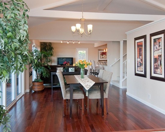 a dining room with wood floors and white walls