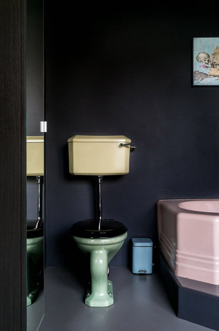 a bathroom with a toilet, sink and bathtub in the same color as the walls