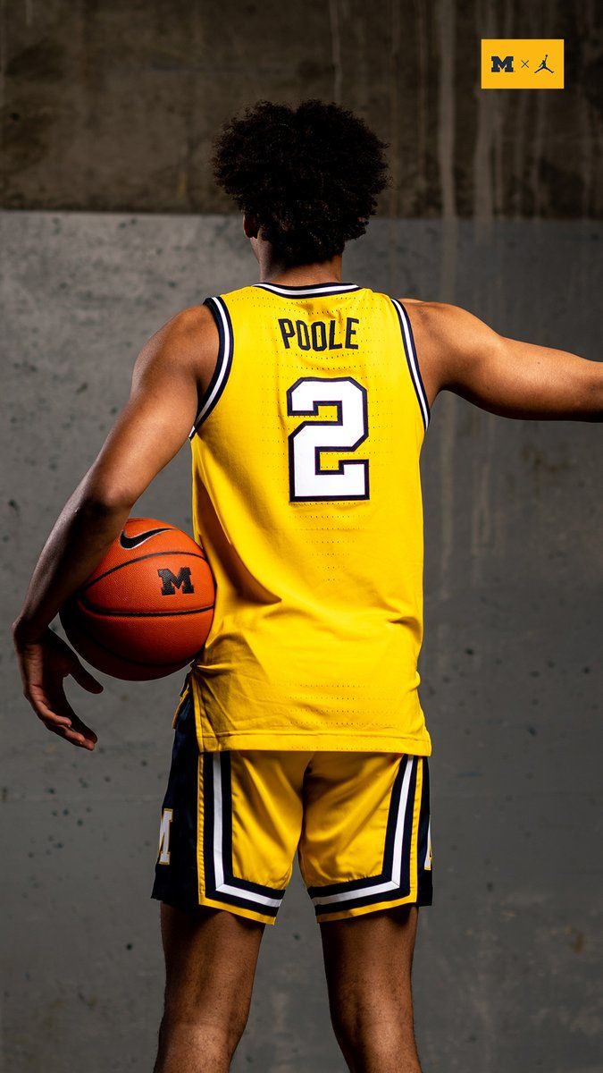 a basketball player in yellow jersey holding a ball