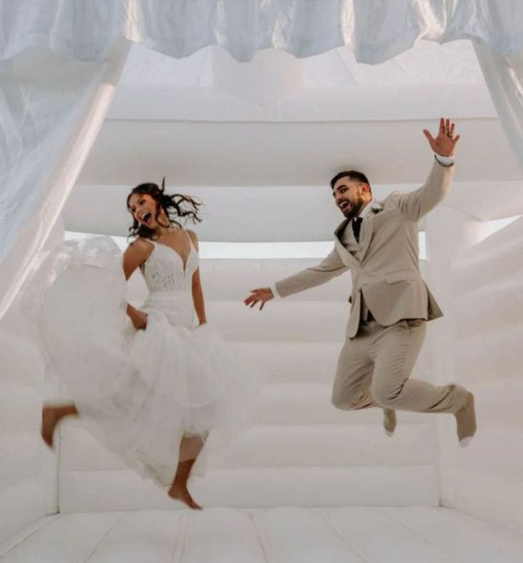 a man and woman are jumping in the air