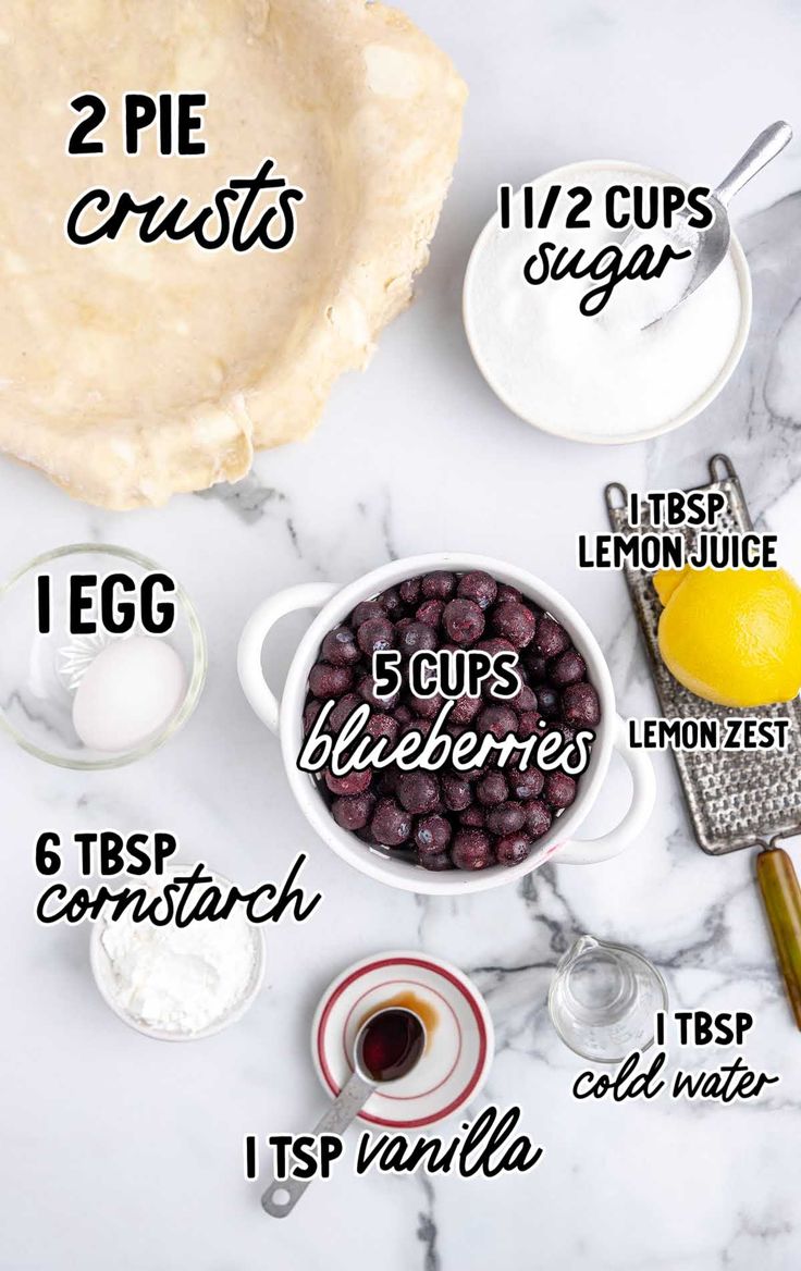 ingredients to make blueberry lemonade pie on a marble countertop with text overlay