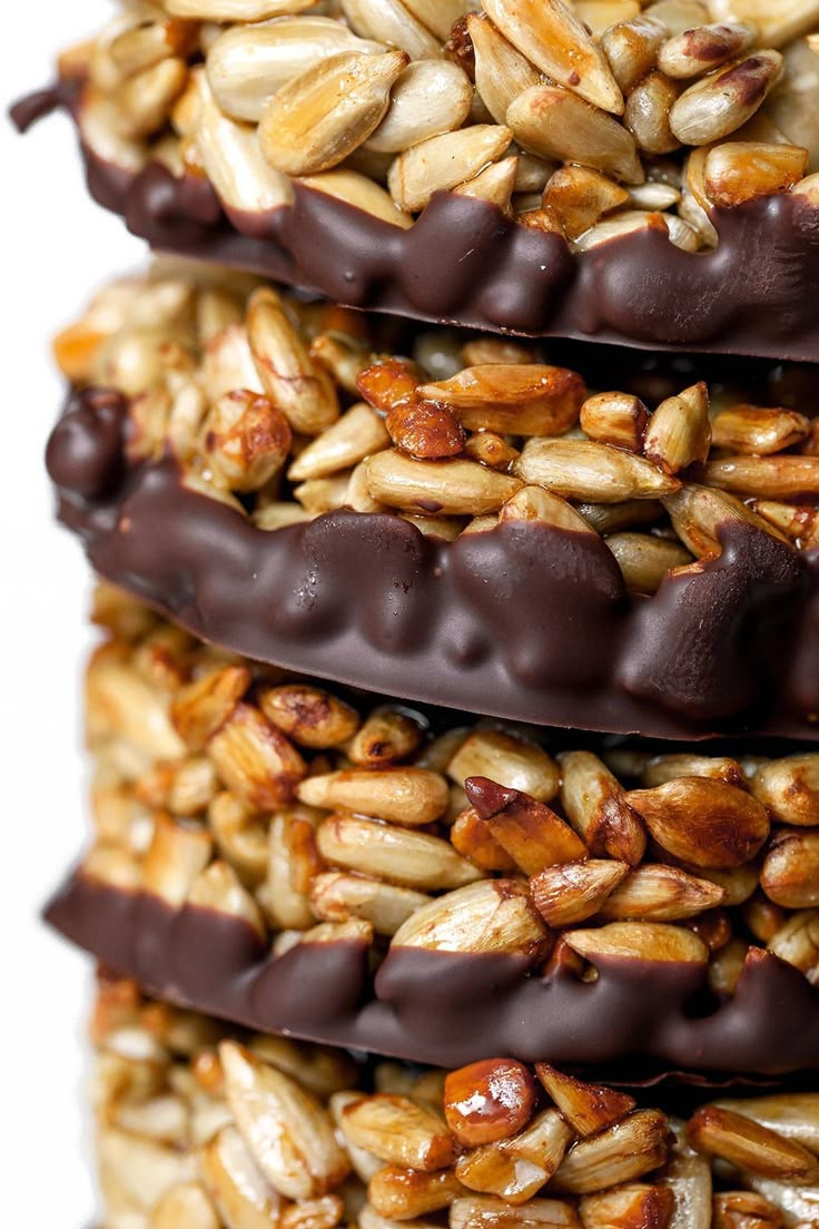 three pieces of chocolate and nuts stacked on top of each other