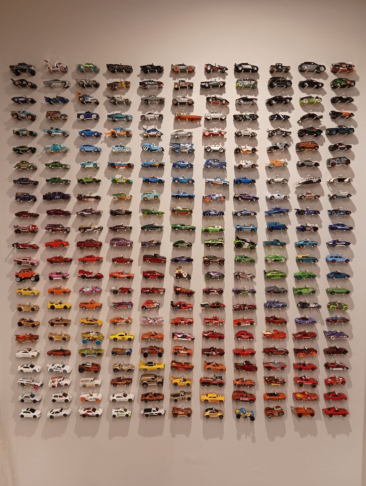 a large display of toy cars on a wall