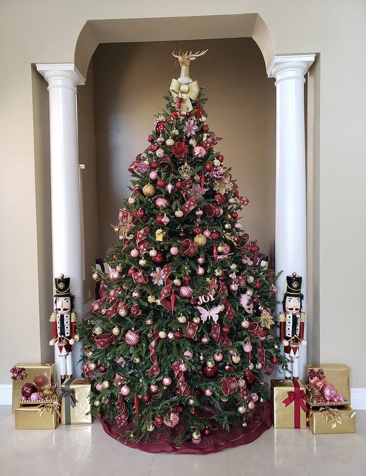 a decorated christmas tree in the corner of a room