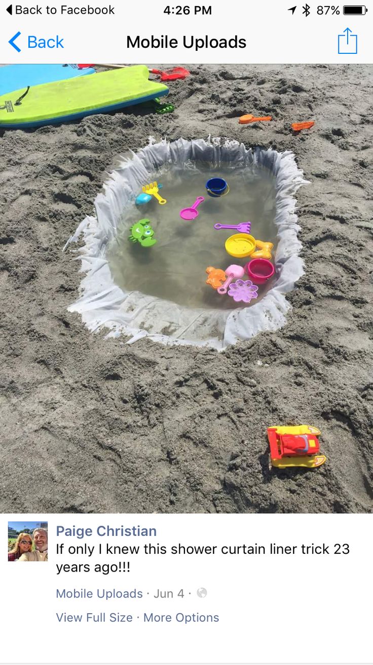 an image of a beach scene with toys in the sand and on the phone screen