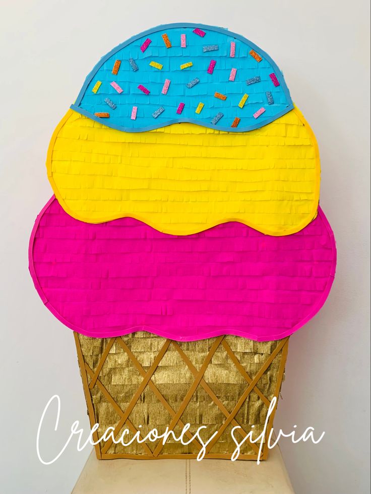 an ice cream cone with sprinkles on it is made out of paper