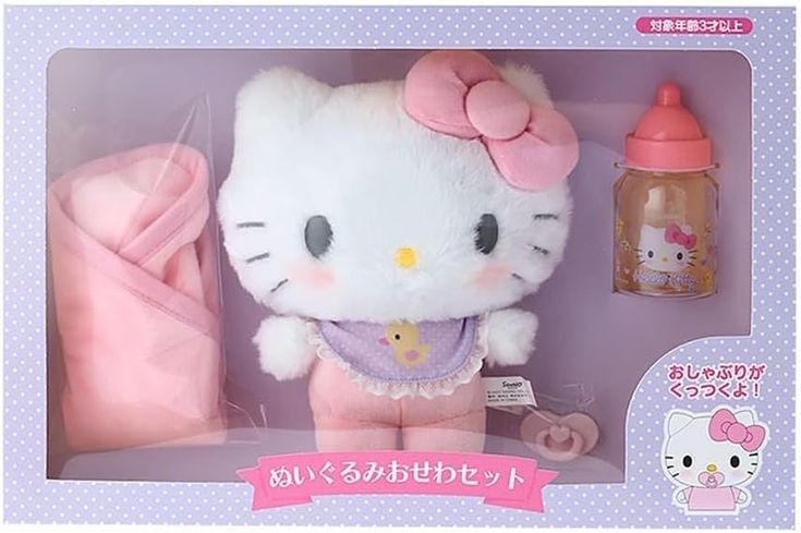 the hello kitty doll is in its box with her pink outfit and baby bottle next to it