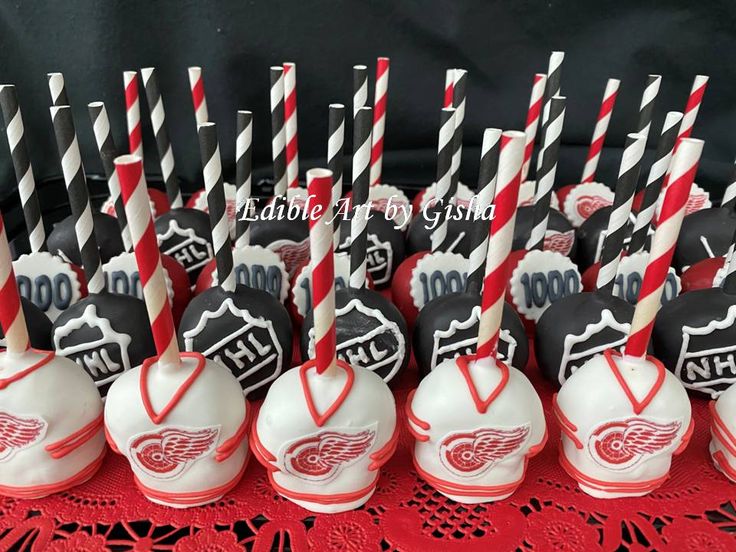 hockey themed cake pops are lined up on a table