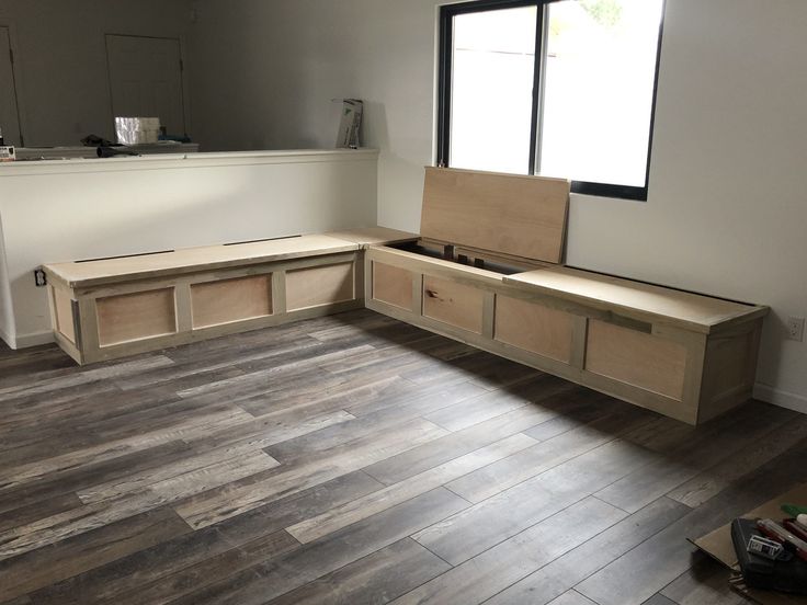 an empty room with unfinished furniture in the middle and hard wood flooring on the other side