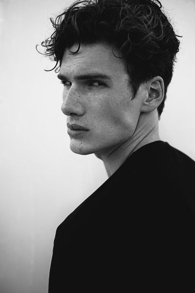 black and white photograph of a man with curly hair