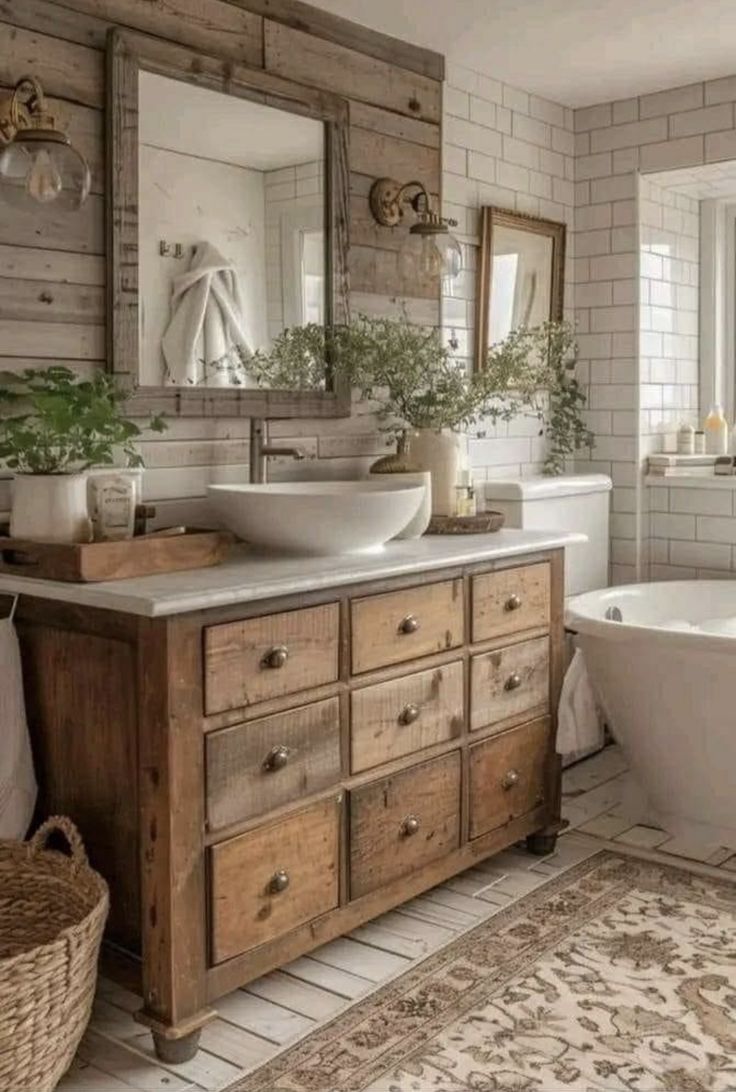 a bathroom with a sink, bathtub and large mirror above the tub is decorated in rustic style