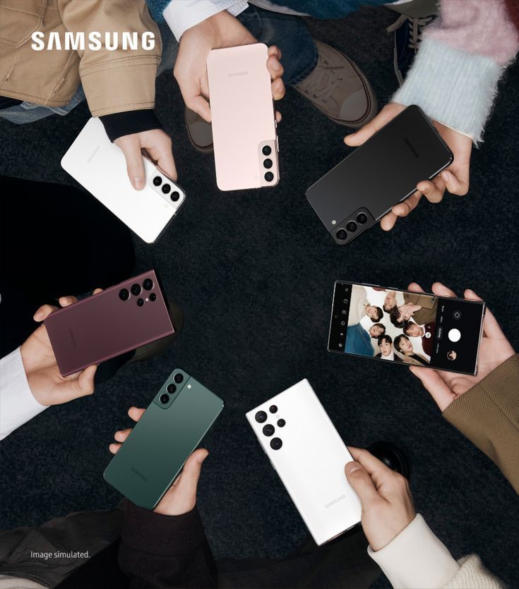 several people holding cell phones in the middle of a circle with their hands on them