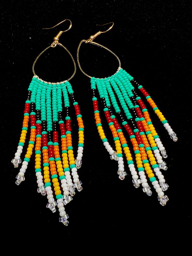 two pairs of colorful beaded earrings on black background