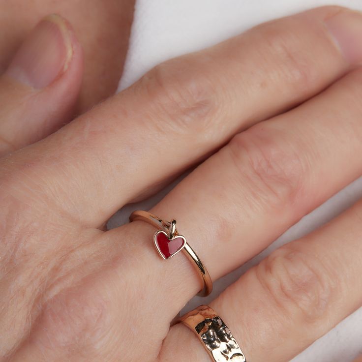 Hold a tiny treasure of love close to you with our adorable Valentines Ring. Perfect for matching moments between best friends or gifted as a sweet symbol of affection, each ring features a dainty red heart that moves delicately against the ring band.&nbsp;18K Champagne Gold PlatedHeart: 0.24Sent with love in a complimentary gift box Red Heart-shaped Promise Jewelry, 14k Gold Heart-shaped Proposal Jewelry, Adjustable Heart-shaped Couple Rings For Valentine's Day, Rose Gold Promise Jewelry For Valentine's Day, Double Heart Promise Jewelry For Valentine's Day, Valentine's Day Promise Ring Jewelry With Open Ring Shape, Delicate Tiny Heart Promise Ring, Delicate Heart Promise Ring, Tiny Delicate Heart Promise Ring