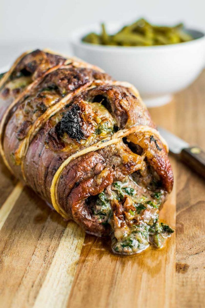 baked stuffed flank steak on a cutting board