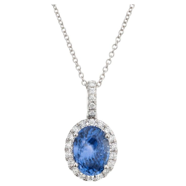 Crisp and bright sapphire and diamond in a classic pendant necklace. A stunning 2.50 Carat oval sapphire is at the center of this 14k white gold setting, accented by 23 round brilliant cut shimmering diamonds, creating a luxurious and eye-catching design. 18 inch 14k white gold chain. The GIA has certified it as natural, no heat. Designed and crafted in the Peter Suchy Workshop. 1 oval blue sapphire, SI approx. 2.50cts GIA Certificate # 2235070041 23 round brilliant cut diamonds, G VS SI approx. Classic Pendant Necklace, Sapphire Diamond Pendant, Gia Certificate, Diamond Pendant Necklace, Sapphire Diamond, Round Brilliant Cut Diamond, Diamond Pendant, Round Brilliant, Blue Sapphire