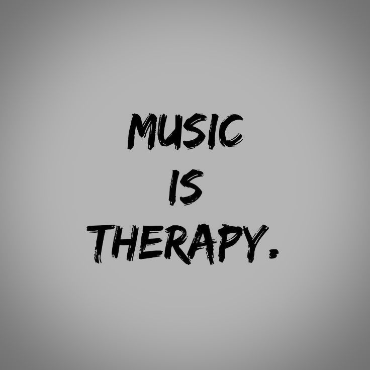 the words music is therapy written in black ink