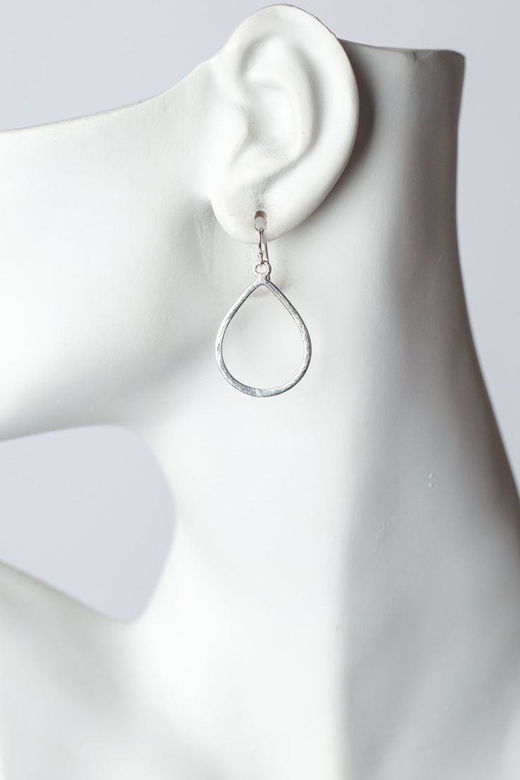 The brushed silver findings in a simple teardrop design. They are created with brushed silver plated brass, and dangle at approximately 1.5" from sterling silver ear wires. Silver Plated Brass (nickel and lead-safe) 1.5", with sterling silver ear wires We hand select our natural materials, thus there may be slight variations in color and/or size that will not detract from the overall aesthetic Our unique handcrafted designer jewelry for women is made in America, each design created individually Modern Silver Teardrop Earrings, Metal Teardrop Earrings With Lever Back, Modern Nickel-free Dangle Teardrop Earrings, Silver Metal Teardrop Pendant Drop, Silver Metal Teardrop Pendant, Minimalist Silver Long Drop Teardrop Earrings, Nickel-free Long Drop Teardrop Earrings, Nickel Free Long Drop Teardrop Earrings, Silver Metal Teardrop Earrings For Everyday