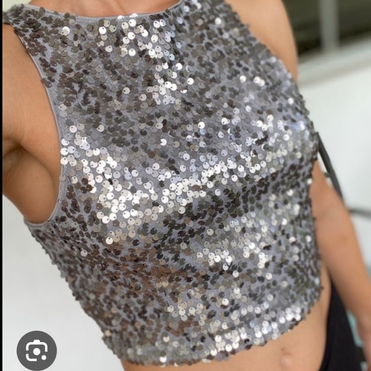 Express Sequin Halter Crop Top! It Is Super Trendy And Can Be Worn With Leggings, Jeans, Pants, Or Shorts Making It Very Versatile. The Inside Is A Soft Material And Is 100% Polyester Making It A Comfy Yet Stylish Addition To Your Wardrobe. Perfect For Upcoming Christmas Parties & New Years Silver Crop Top For Summer Party, Elegant Silver Crop Top For Party, Silver Sequined Sleeveless Crop Top, Fitted Silver Sleeveless Crop Top, Silver Crop Top For Party Season, Silver Sleeveless Crop Top For Evening, Silver Sleeveless Crop Top For Night Out, Fitted Silver Crop Top For Summer, Silver Fitted Crop Top For Night Out