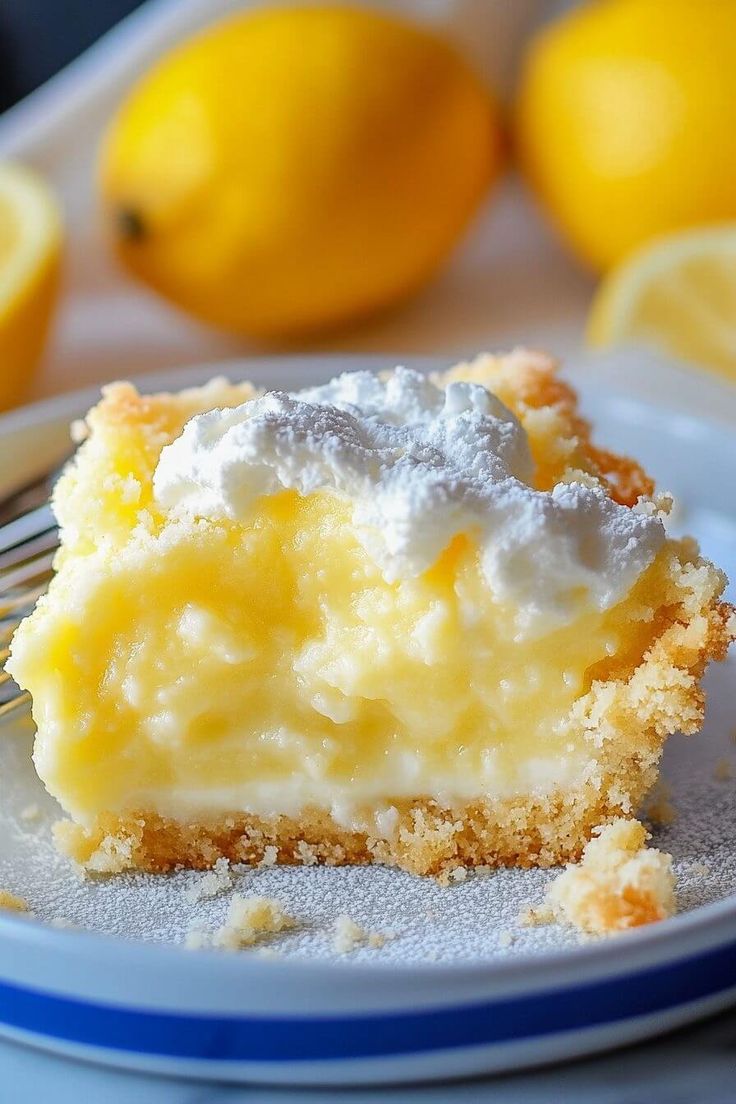 a close up of a piece of cake on a plate with lemons in the background