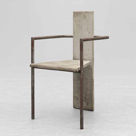 a chair made out of concrete with a wooden frame and arm rests on the ground