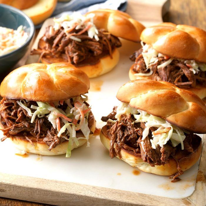 four pulled pork sliders on a cutting board