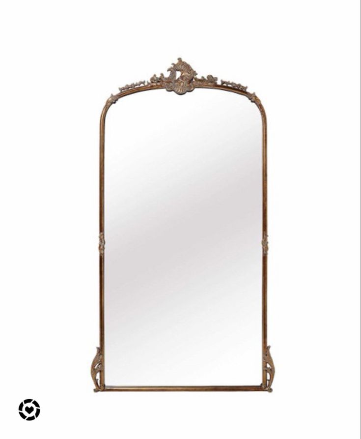 a large mirror with an ornate design on the front and back side, sitting against a white background