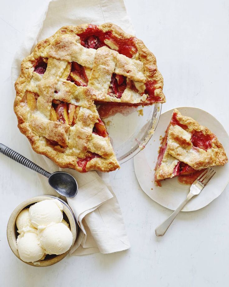 a pie with two slices cut out and ice cream on the side